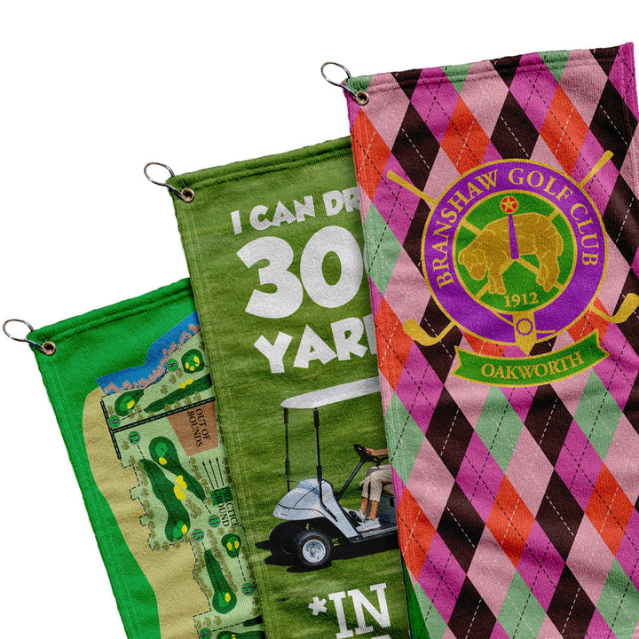 three colorful golf towels hanging from hooks