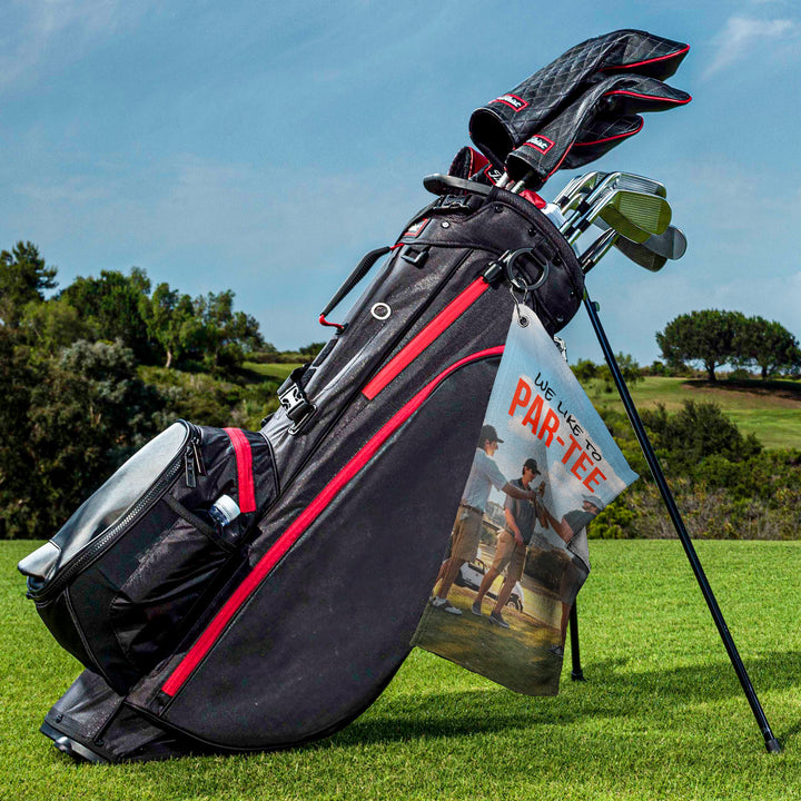 a bag of golf clubs sitting on top of a green field
